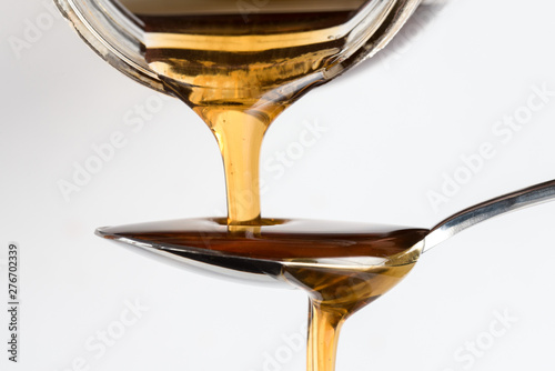 Pouring Maple Syrup on a Spoon photo