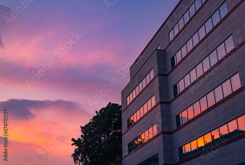 Sky with clouds reflected in windows of modern office building. Business background.