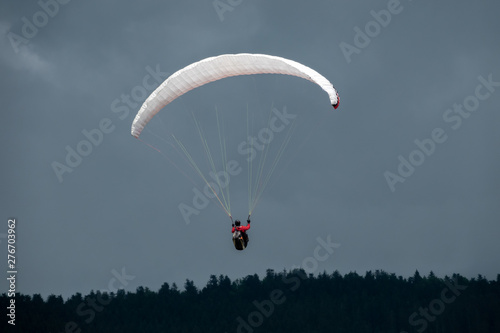 Paraglider in flight with the sky in background