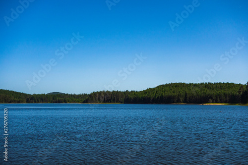View of the landscape of the lake in the mountain during summer. Copy space for text on blue sky.