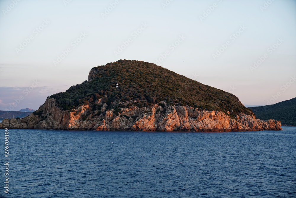 Shining mountain during sunrise on a ferry of corsica ferries before the arrival at Golfo Aranci 