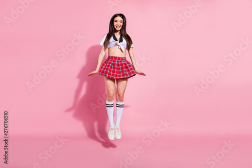 Full length body size view of her she nice-looking attractive lovely adorable sweet charming slender cheerful cheery straight-haired lady jumping up having fun isolated over pink pastel background