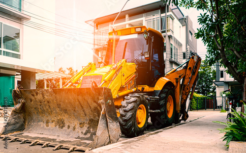 Yellow Bulldozer prepare for road repair in housing Estate