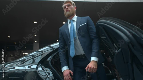 Businessman comes out of a executive car, top manager comes to the important meet, famous rich man comes out of his car with personal driver, business class car, Prores 422 HQ photo
