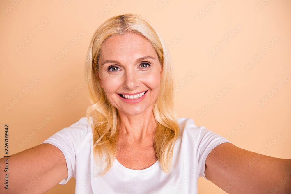 Closeup photo of adorable lady make take selfies weekend mood wear white casual t-shirt isolated pastel beige background