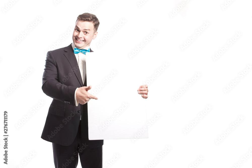 Funny man in a suit shows on a white sheet. On a white background in the studio. Funny man in a suit shows on a white sheet. On a white background in the studio.