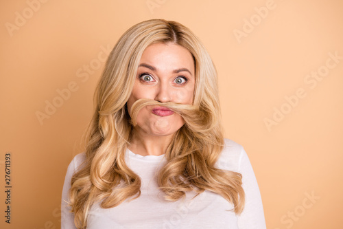 Close up photo of pretty lady have holidays make faces fooling white t-shirt isolated over beige background