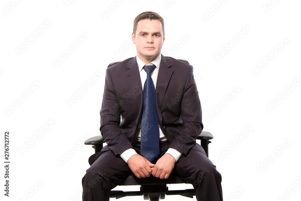 Businessman sitting in an armchair on a white background in the studio. Businessman sitting in an armchair on a white background in the studio.