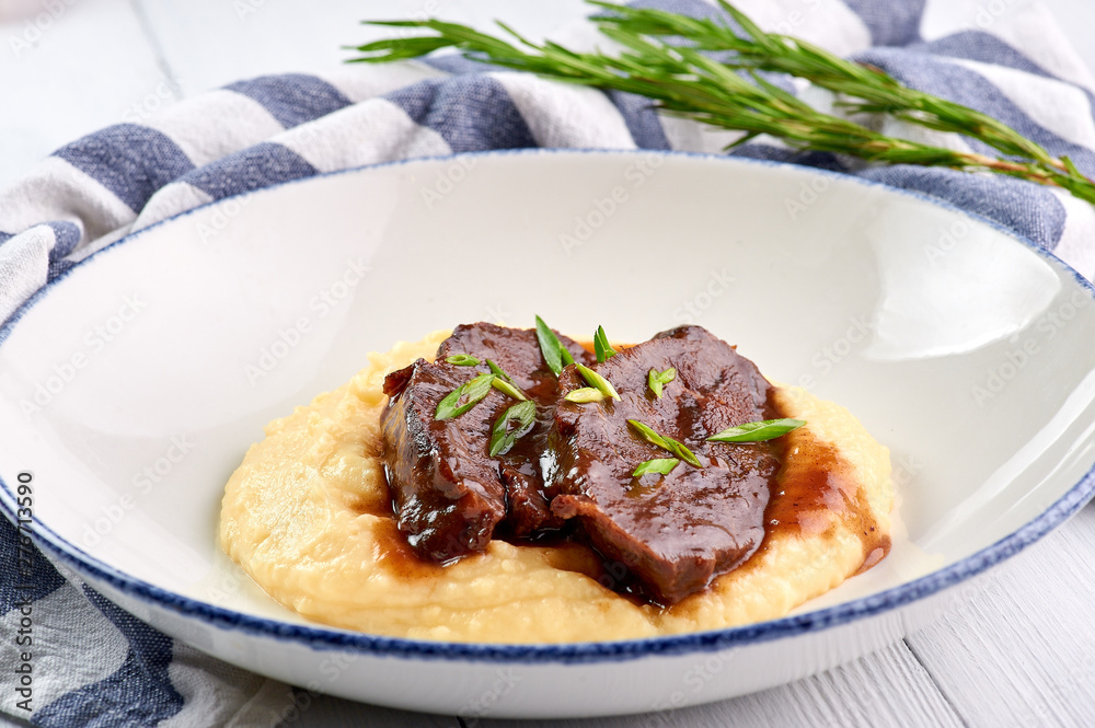 Pork Cheeks In Demiglas Sauce with mashed potatoes. Carrillada de cerdo in demi glace sauce. Traditional Spanish cuisine dish Pork Cheeks In Demiglas Sauce with mashed potatoes. Carrillada de cerdo in demi glace sauce. Traditional Spanish cuisine dish