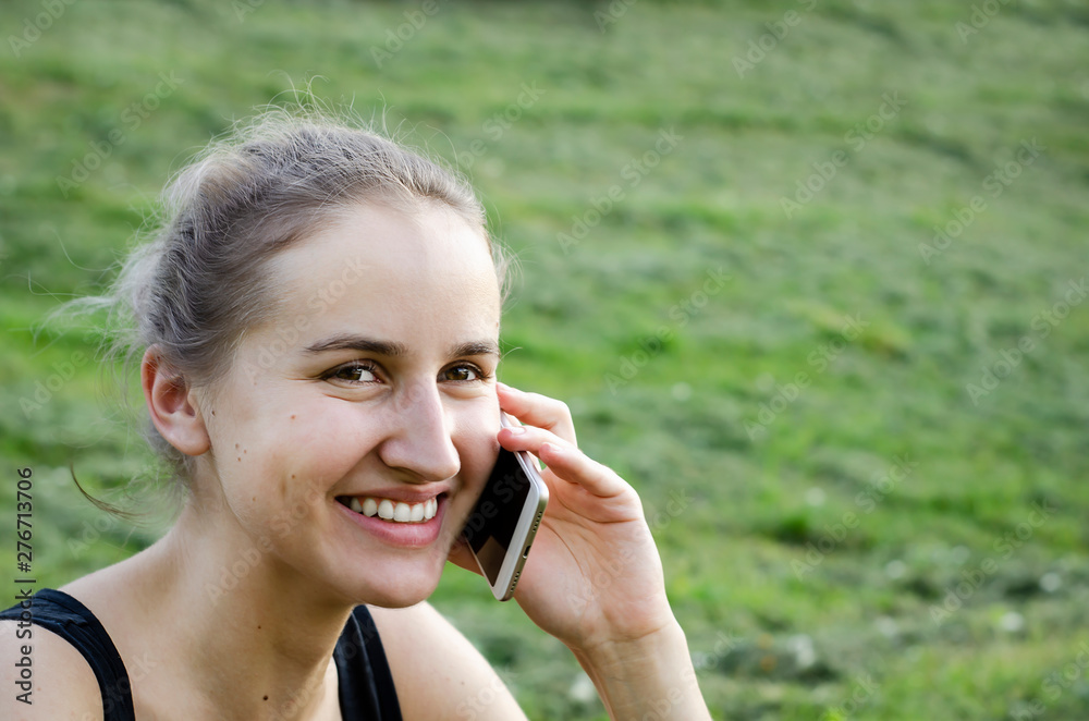 Girl talking on the phone and laughing. Photo. Girl talking on the phone and laughing. Photo.