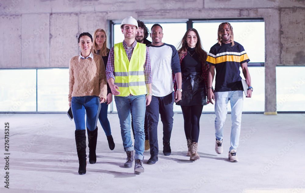 Fototapeta premium young multiethnic business people walking through unfinished startup office