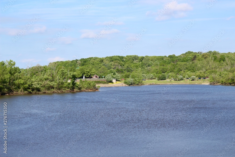 The peaceful lake in the park on a sunny spring day. The peaceful lake in the park on a sunny spring day.