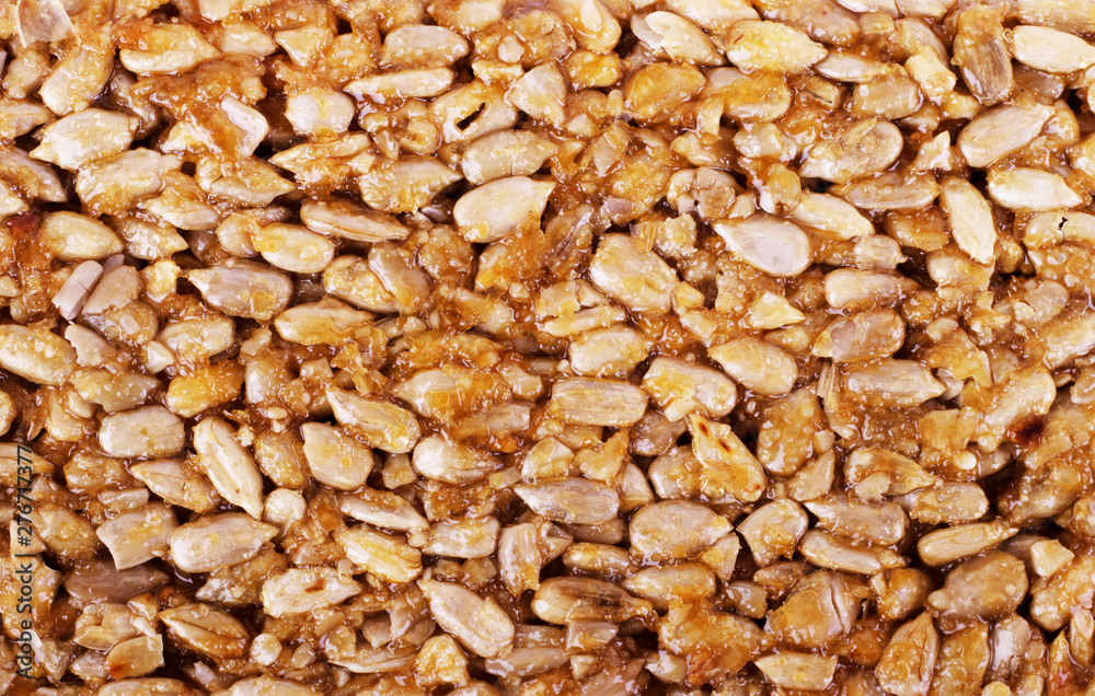 Kozinaki from golden, roasted peanuts beans as a background, texture. Macro shooting, close-up. Kozinaki from golden, roasted peanuts beans as a background, texture. Macro shooting, close-up.
