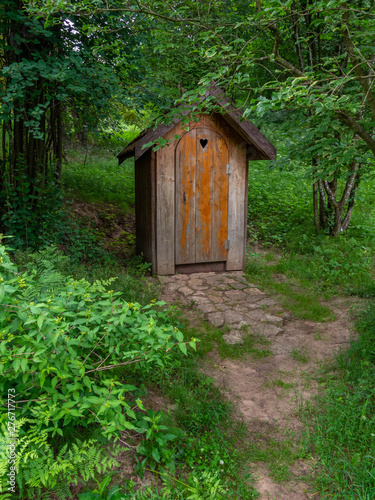 Fototapeta Naklejka Na Ścianę i Meble -  Old wooden restroom in a forest