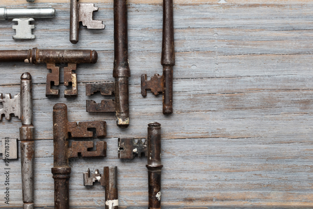 Vintage old fashioned keys on a rustic wooden background. Security concept