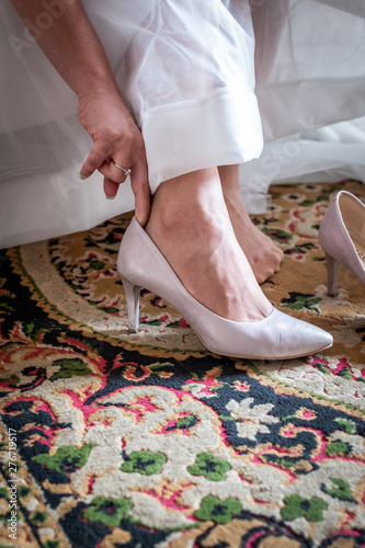 Bride taking her shoes