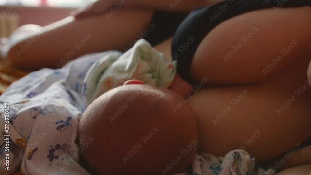 Mother breastfeeds the newborn baby. Close up shot. Mother breastfeeds the newborn baby. Close up shot.