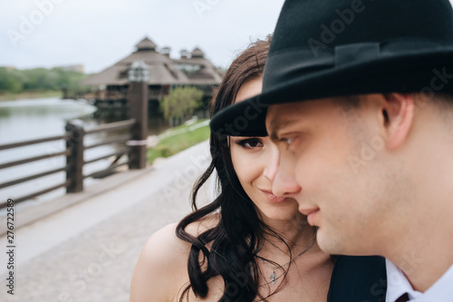 Wedding idea and an unusual portrait of the newlyweds. Half of the face of the bride and the profile of the groom in a hat. Concept and phtography. © shchus
