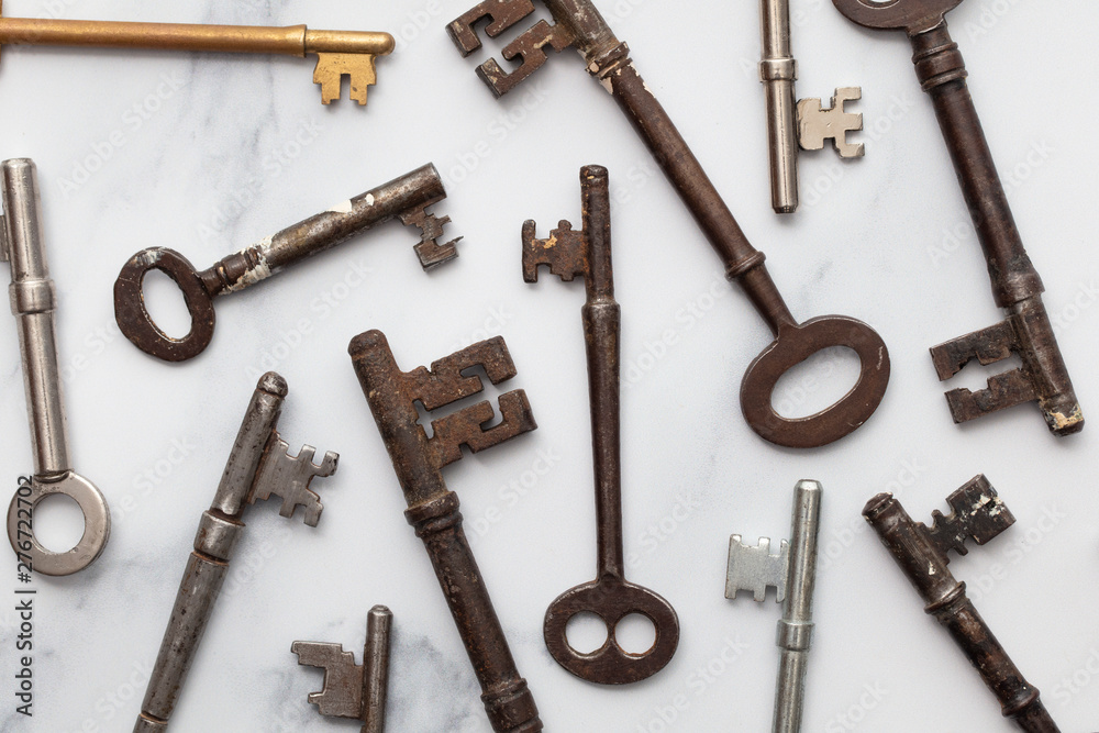 Large set of vintage keys on a plain background. Safety and security concept