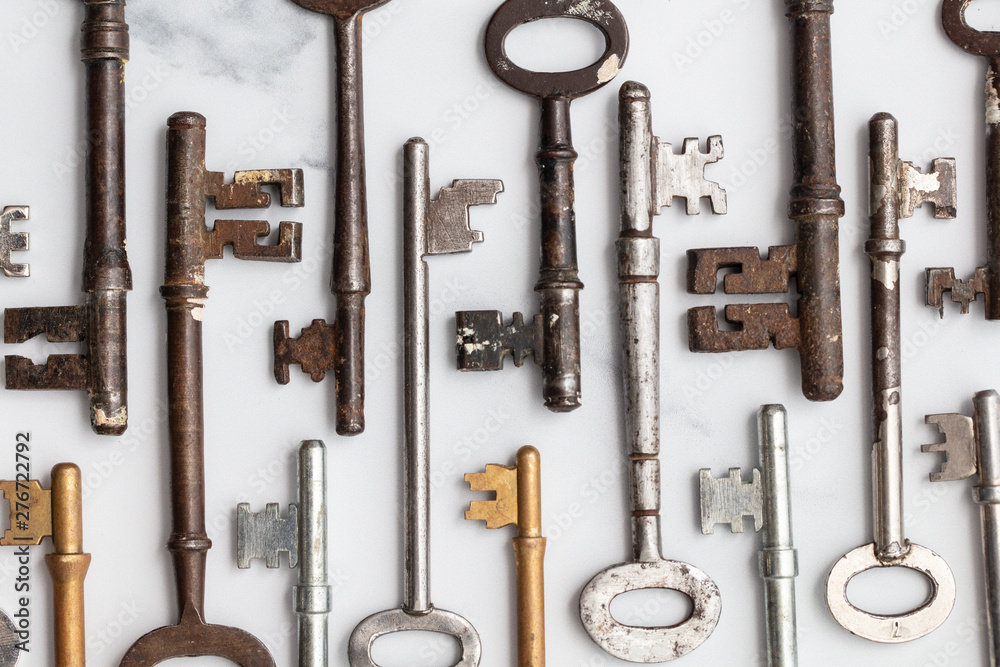 Obraz premium Large set of vintage keys on a plain background. Safety and security concept