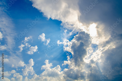 Dramatic cloudscape. Sky background with gray clouds and sunlight