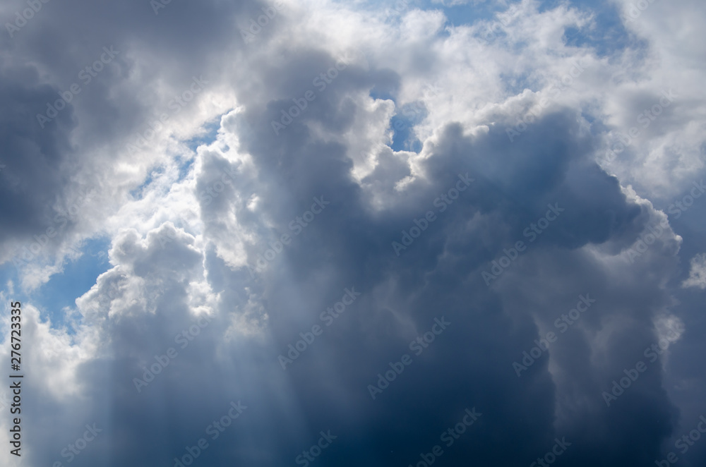 Background of dramatic clouds the sun's rays breaking through the thunderclouds Background of dramatic clouds the sun's rays breaking through the thunderclouds
