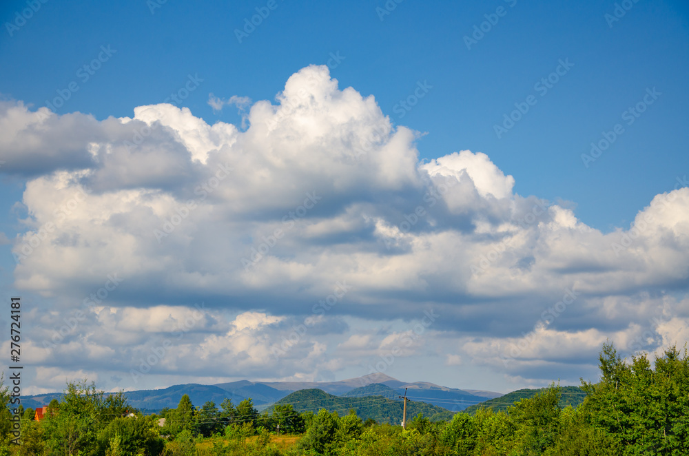 Colorful landscape background with white cumulus clouds Colorful landscape background with white cumulus clouds