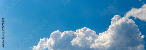 Panorama of blue sky with white cumulus clouds photo