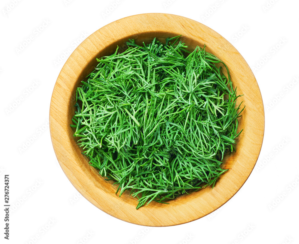 Fresh dill a wooden bowl isolated on a white background. Top view. Fresh dill a wooden bowl isolated on a white background. Top view.