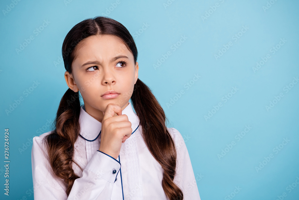 Close up photo of thoughtful kid have dilemma difficult test touch chin wear white blouse isolated over blue background Close up photo of thoughtful kid have dilemma difficult test touch chin wear white blouse isolated over blue background