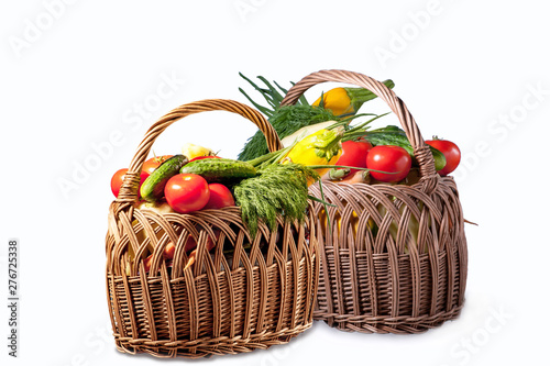 Fresh vegetables in two baskets isolated on white