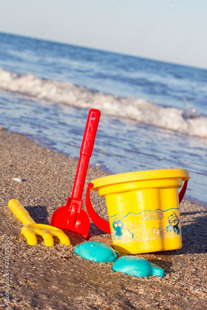 Children's toys on the beach. Spatula, rake, bucket and molds. Children's toys on the beach. Spatula, rake, bucket and molds.