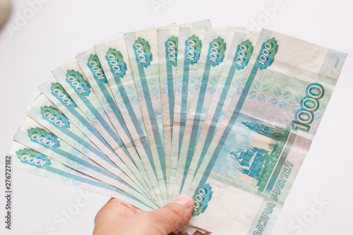 Man counting money, economy concept, allocation of money. hands giving money isolated on white background. of one thousand Russian rubles are isolated on a white background.