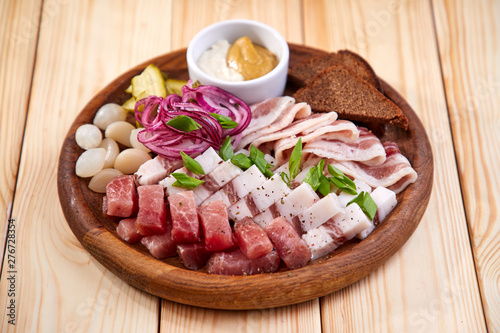 meat appetizer on the wooden background