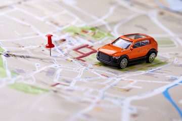 travel concept - small toy car on the map