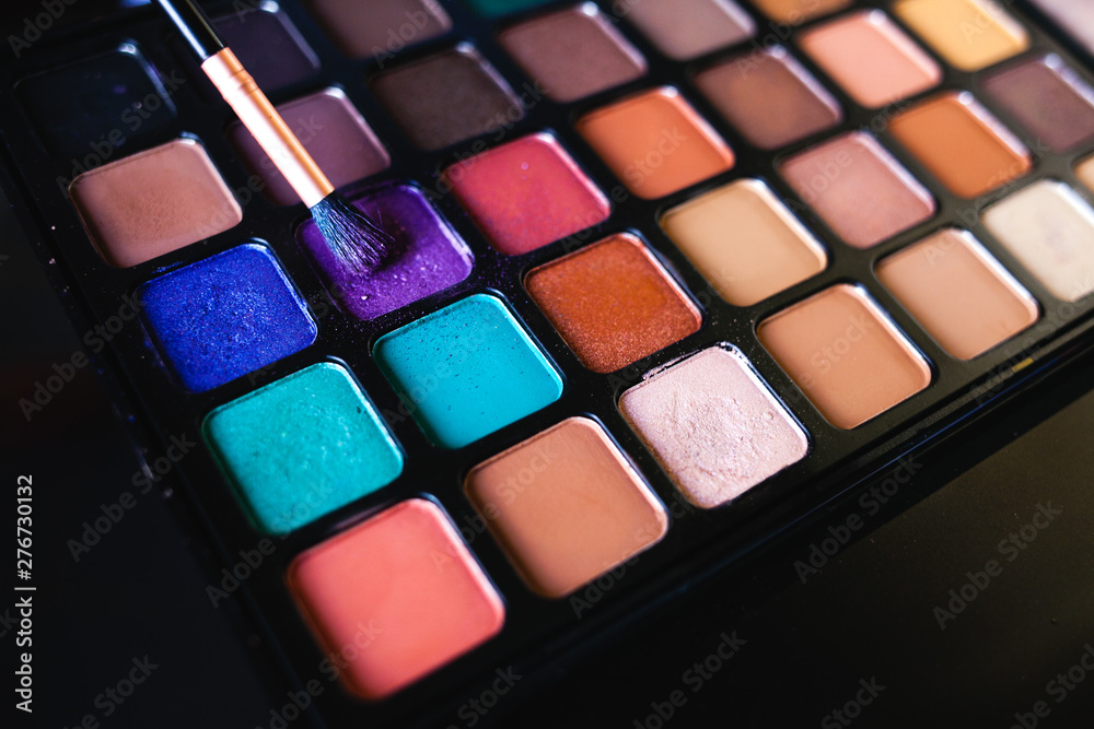 Colorful make up eye shadow and brush.