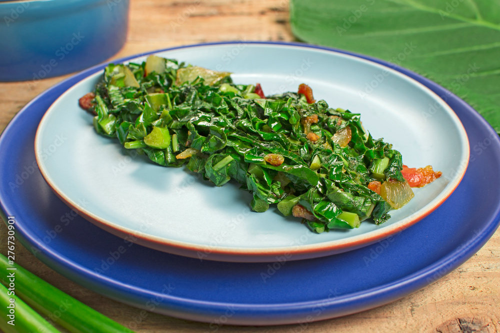 Braised exotic edible plant recipe (Xanthosoma sagittifolium) called taioba in Brazil close Braised exotic edible plant recipe (Xanthosoma sagittifolium) called taioba in Brazil close