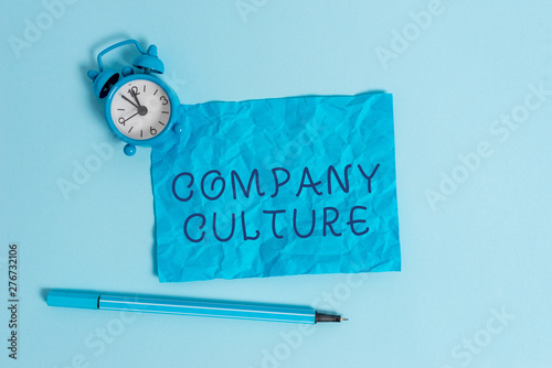 Writing note showing Company Culture. Business concept for The environment and elements in which employees work Metal vintage alarm clock crushed sheet marker sky colored background photo