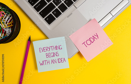 Text sign showing Everything Begins With An Idea. Business photo text steps you take to turn an idea into a reality Trendy metallic laptop sticky notes clips container pencil colored background