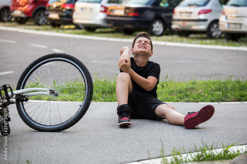 Boy injury hurts from falling bike, hurt on his arms, pain ache from falling off the bicycle