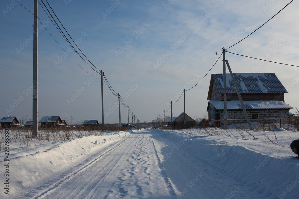 winter cleared road travel among the snowdrifts in the winter in the Siberian village