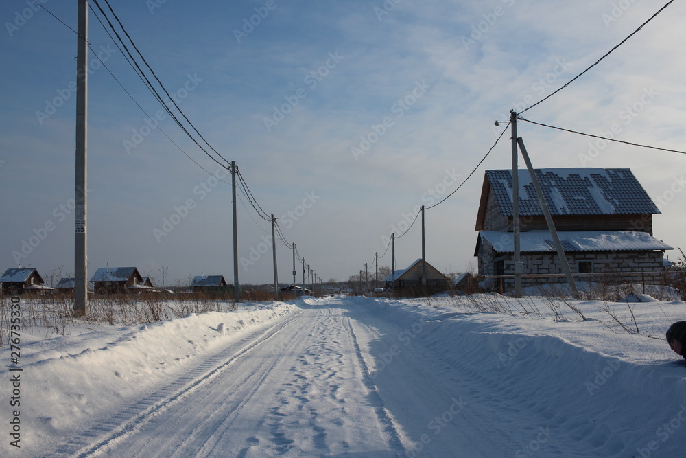 winter cleared road travel among the snowdrifts in the winter in the Siberian village winter cleared road travel among the snowdrifts in the winter in the Siberian village