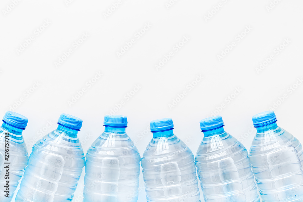 Plastic bottles with pure water on white background top view space for text Plastic bottles with pure water on white background top view space for text