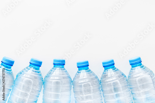 Plastic bottles with pure water on white background top view space for text