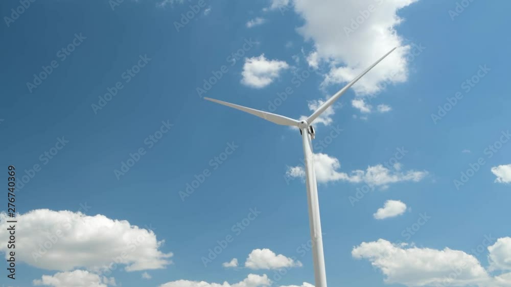 Wind generator on bright cloudy sky background Wind generator on bright cloudy sky background