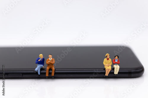 Miniature people : Businessman sitting on smartphone by apply technology for communication. Image use for technology business.