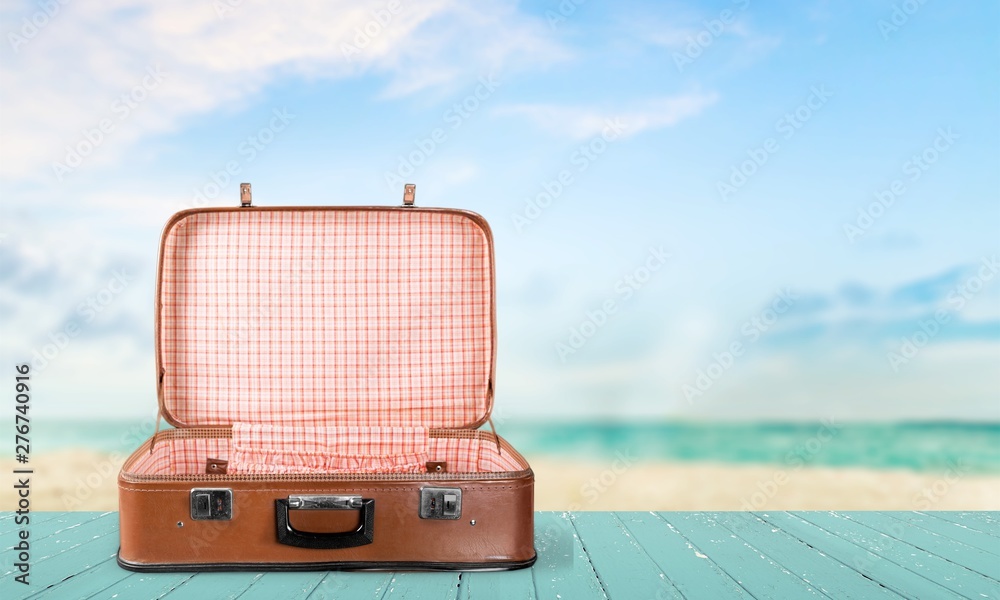 Retro suitcase with travel objects  on sea background - obrazy, fototapety, plakaty 
