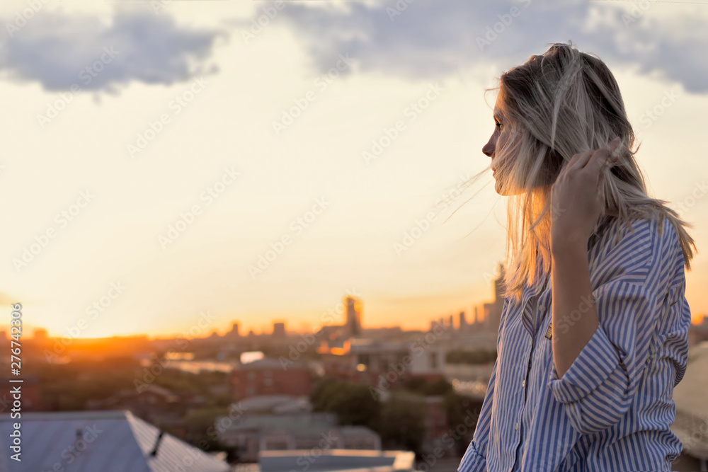 young woman looking at sunset