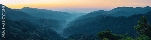 web banner and panorama of earth day and environment care travel concept from beautiful landscape of tropical forest with haze with soft focus of layer mountain background