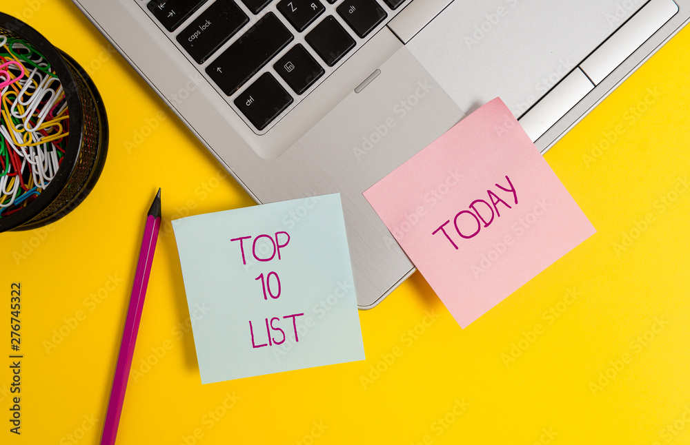 Text sign showing Top 10 List. Business photo text the ten most important or successful items in a particular list Trendy metallic laptop sticky notes clips container pencil colored background Text sign showing Top 10 List. Business photo text the ten most important or successful items in a particular list Trendy metallic laptop sticky notes clips container pencil colored background